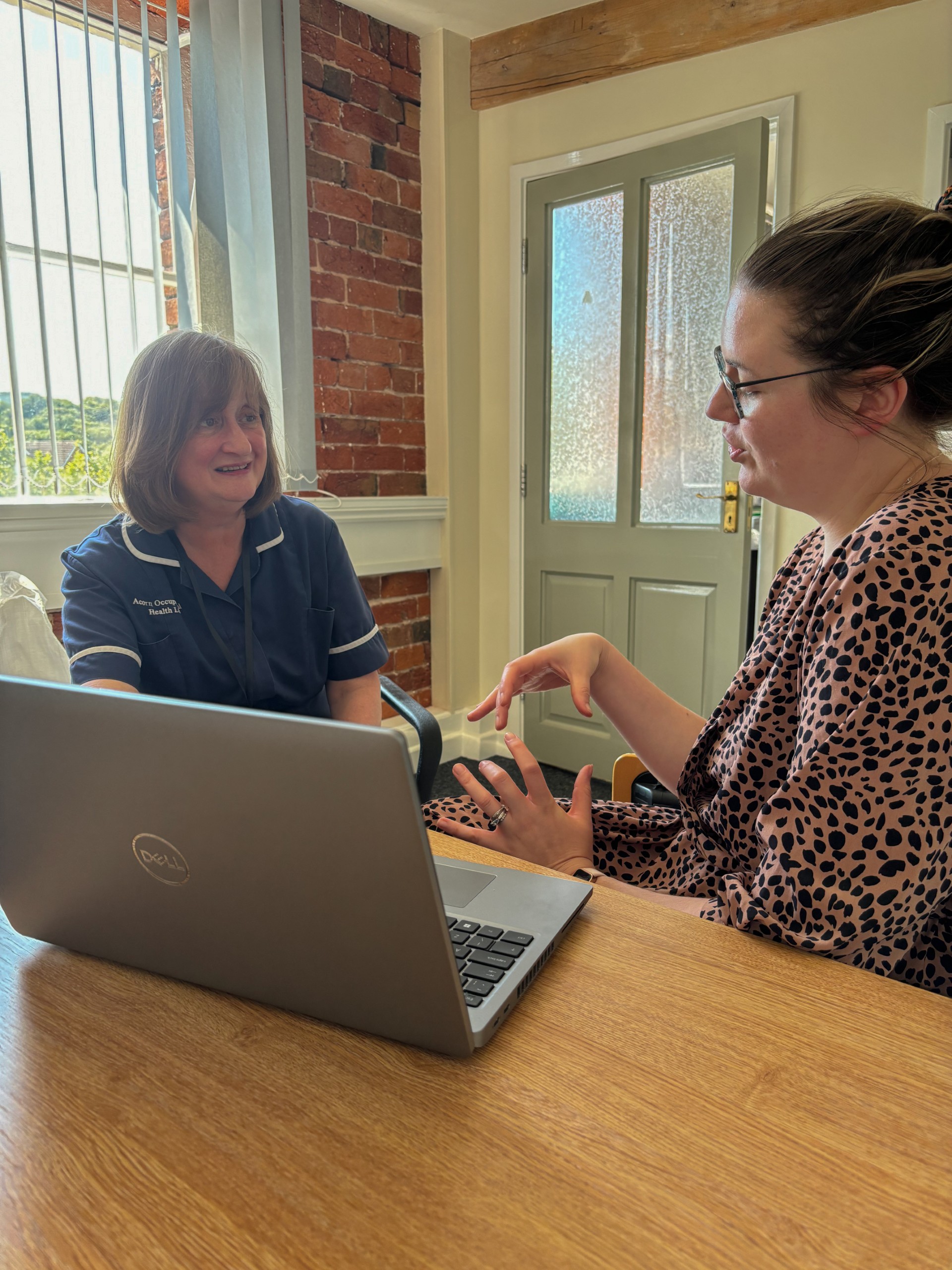 A Management Referral session where two people are discussing and using a laptop.
