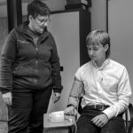 A nurse taking an employee's blood pressure as part of a Well Person Medical